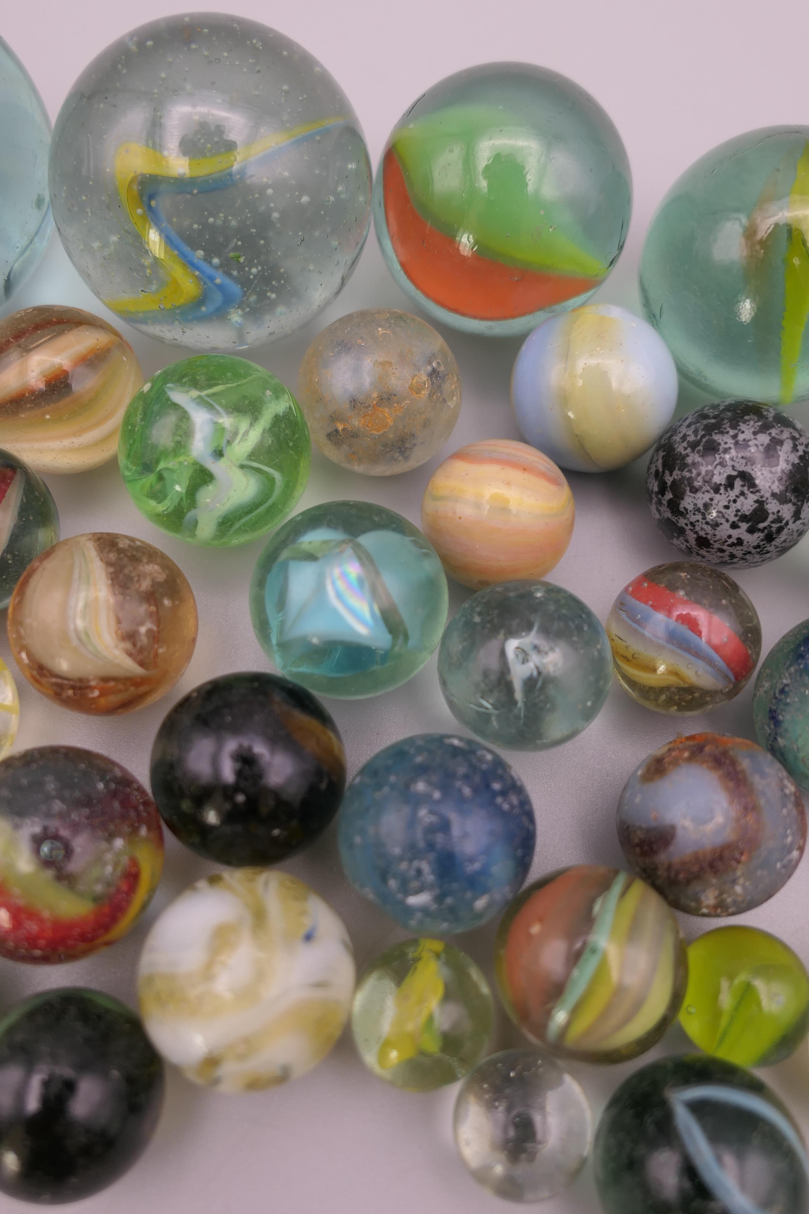 Four antique glass marbles (three approximately 1 inch diameter and the other 15/16th of an inch - Image 4 of 14