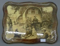 A wall plaque depicting gypsy encampment. 43.5 cm wide.