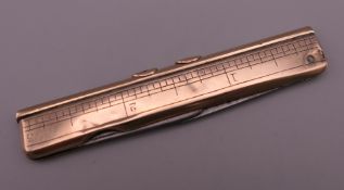 A 9 ct gold pocket knife, with rule and two propelling pencils. 7.5 cm long.