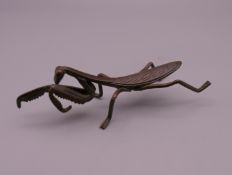 A bronze model of a locust. 8.5 cm long.