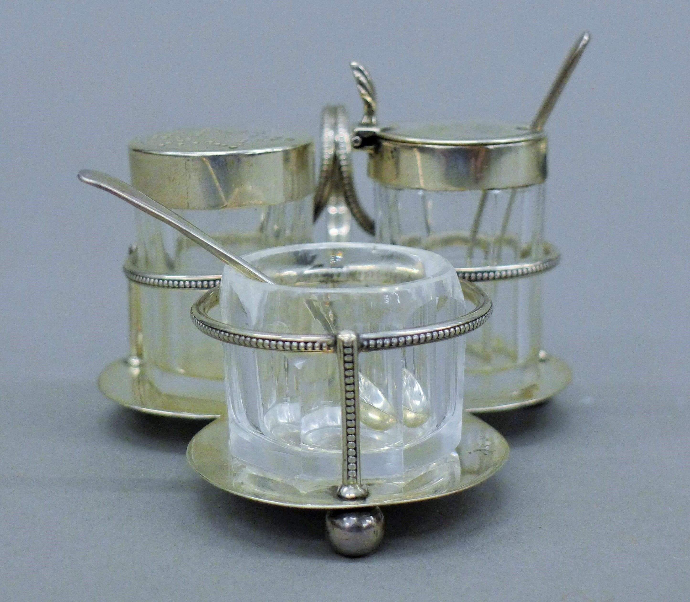 A silver condiment set, hallmarked for London 1882, makers mark Hukin & Heath. 8.5 cm long. - Image 2 of 11