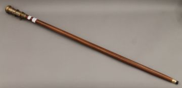 A walking stick mounted with a compass and telescope. 99 cm long.