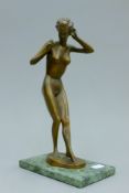 A 1920's bronze model of a nude female mounted on a marble base. 30.5 cm high.