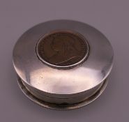 A coin set silver pill box. 4 cm diameter.
