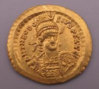 A gold Roman coin. 4.4 grammes. Approximately 2 cm diameter.