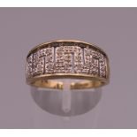 A 9 ct gold diamond Greek key design ring. Ring size Q. 3.3 grammes total weight.