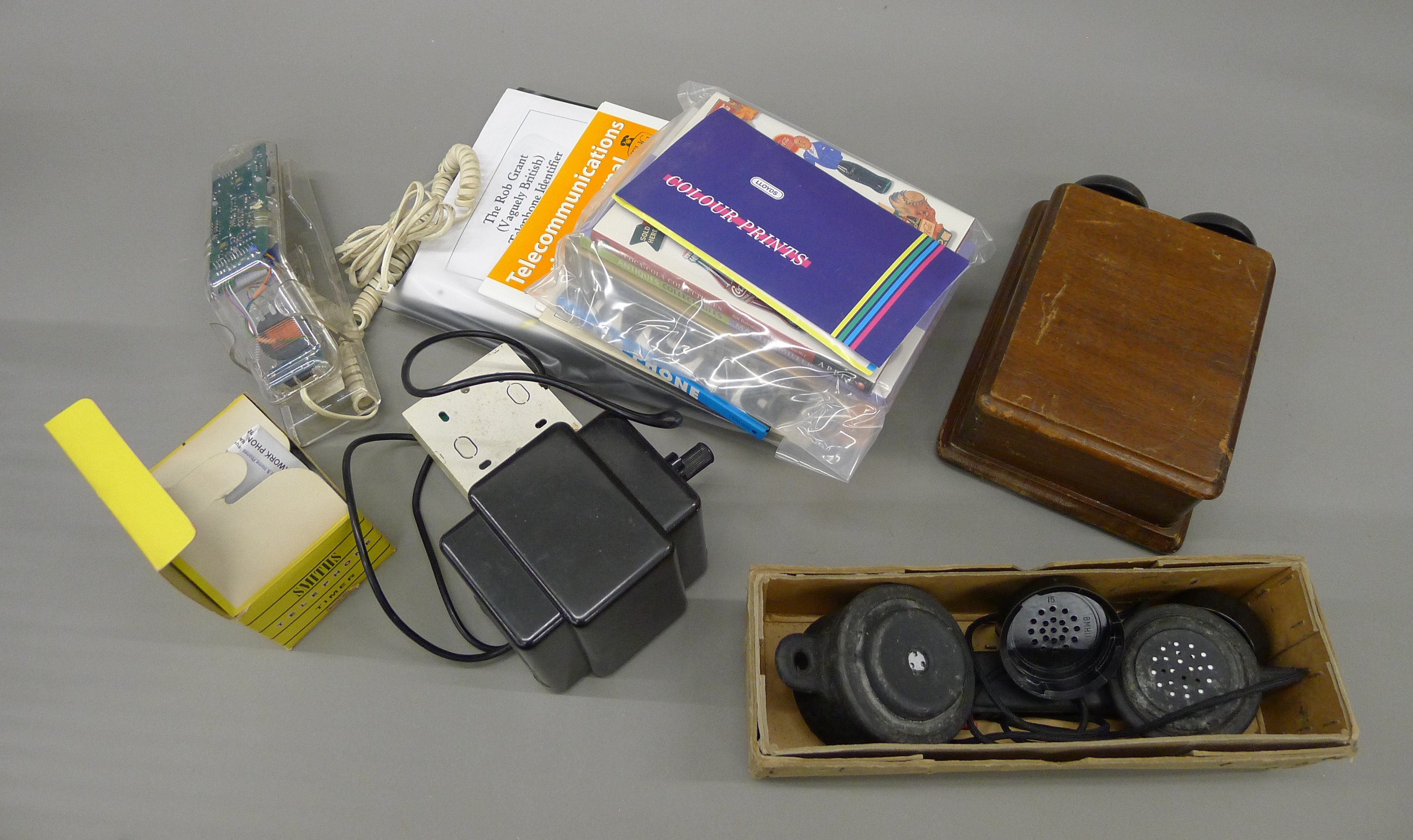 A box of various novelty telephones and telephone equipment.