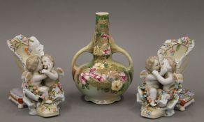 A pair of florally encrusted porcelain vases formed as shoes and a Japanese vase. The latter 17.