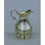 A Victorian silver cream jug, hallmarked for London 1842, maker's mark William Moulson. 12 cm high.