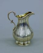 A Victorian silver cream jug, hallmarked for London 1842, maker's mark William Moulson. 12 cm high.
