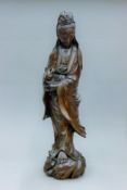 A 19th century silver wire inlaid wooden model of Guanyin. 61 cm high.