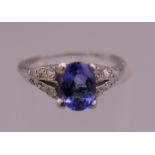 A platinum diamond and tanzanite ring. Ring size J.