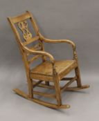 A 19th century solid seated country rocking chair. 55 cm wide.