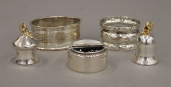 Two silver napkin rings and three small silver boxes.