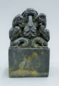 A Chinese bronze dragon seal. 14 cm high.