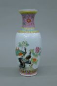 A Chinese famille rose vase painted with peacocks, with six character square seal mark to base.