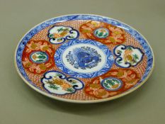 A Japanese Imari style plate decorated with rabbits, with six character mark to base. 19.
