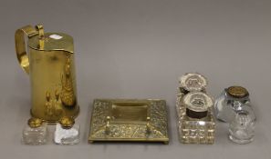 A quantity of various inkwells and a Trench Art jug.