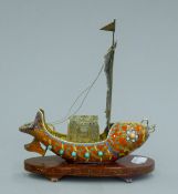 A Chinese silver enamel boat on a plinth base. 18.5 cm high.