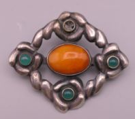 An 830 silver and amber brooch. 5.5 cm wide.