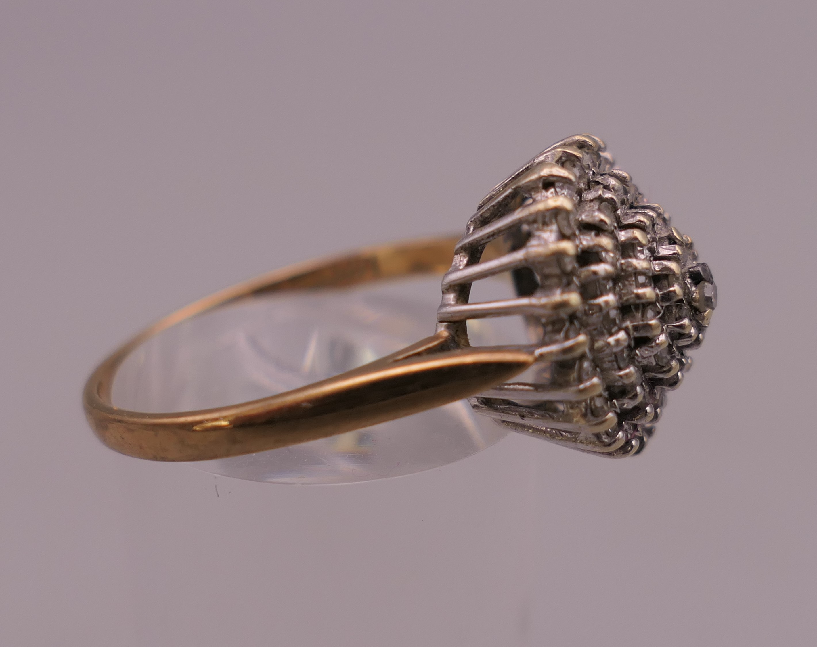 A 9 ct gold 0.5 carat diamond cluster ring. Ring size S/T. 4 grammes total weight. - Image 2 of 6