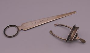 A Barrett & Sons silver letter opener and a silver wishbone letter clip. The largest 17.5 cm long.