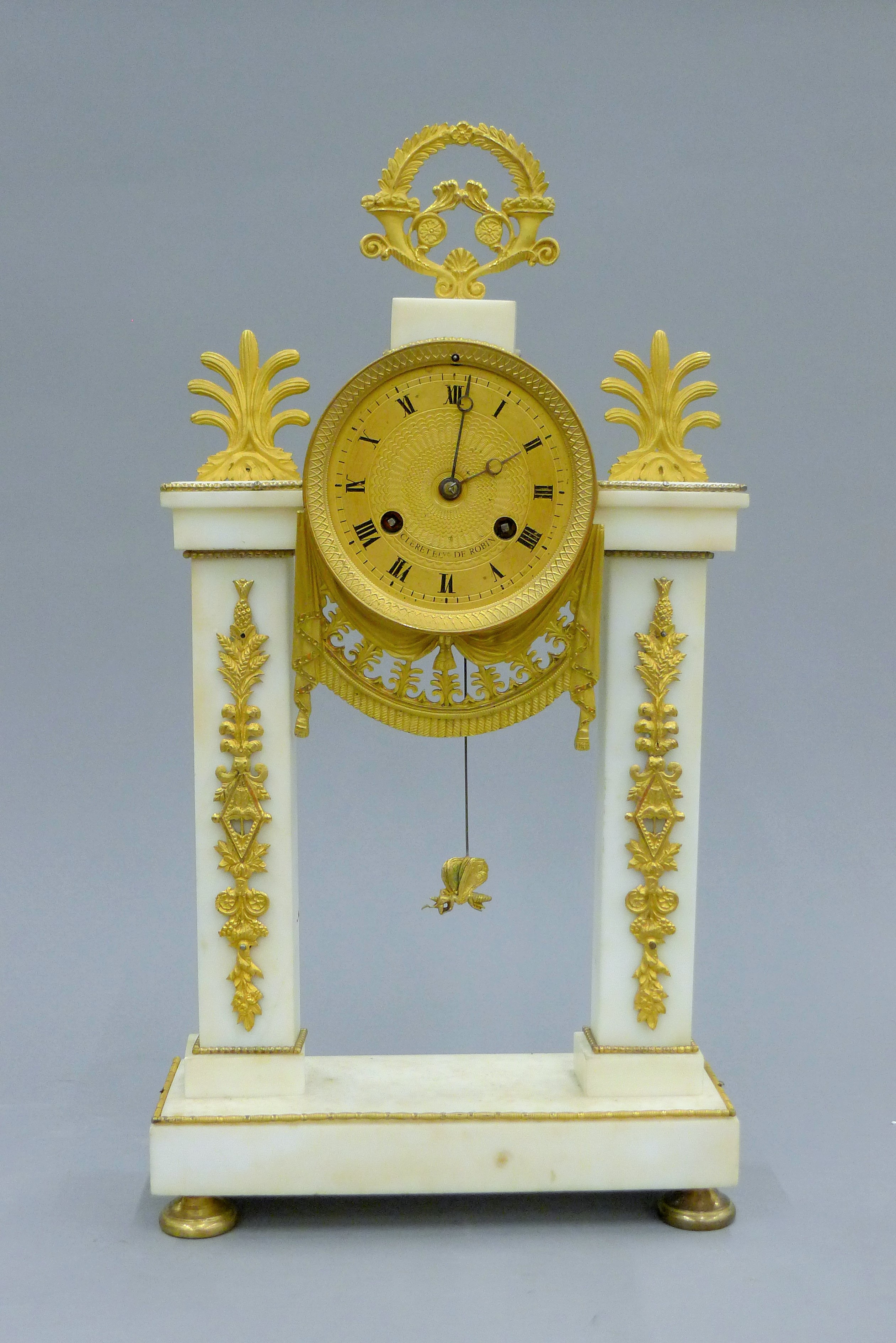 A gilt bronze and white marble portico clock. 42 cm high.