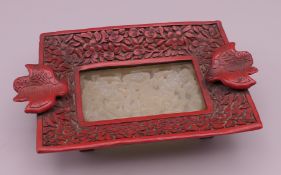 A Chinese pierced jade and cinnabar ashtray. 12 cm wide.