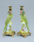 A pair of bronze and porcelain parrot form candlesticks. 35.5 cm high.