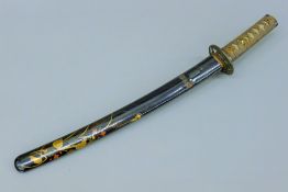 A Japanese tanto with lacquered scabbard. 58 cm long.