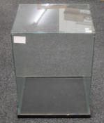 A glass display case. 53 cm wide x 45.5 cm deep x 73 cm high.