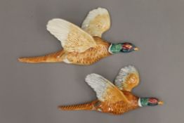 Two Beswick porcelain pheasant wall plaques. The largest 31 cm long.