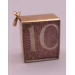 A 9 ct gold emergency ten shilling note charm. 1.5 cm long. 2.6 grammes total weight.