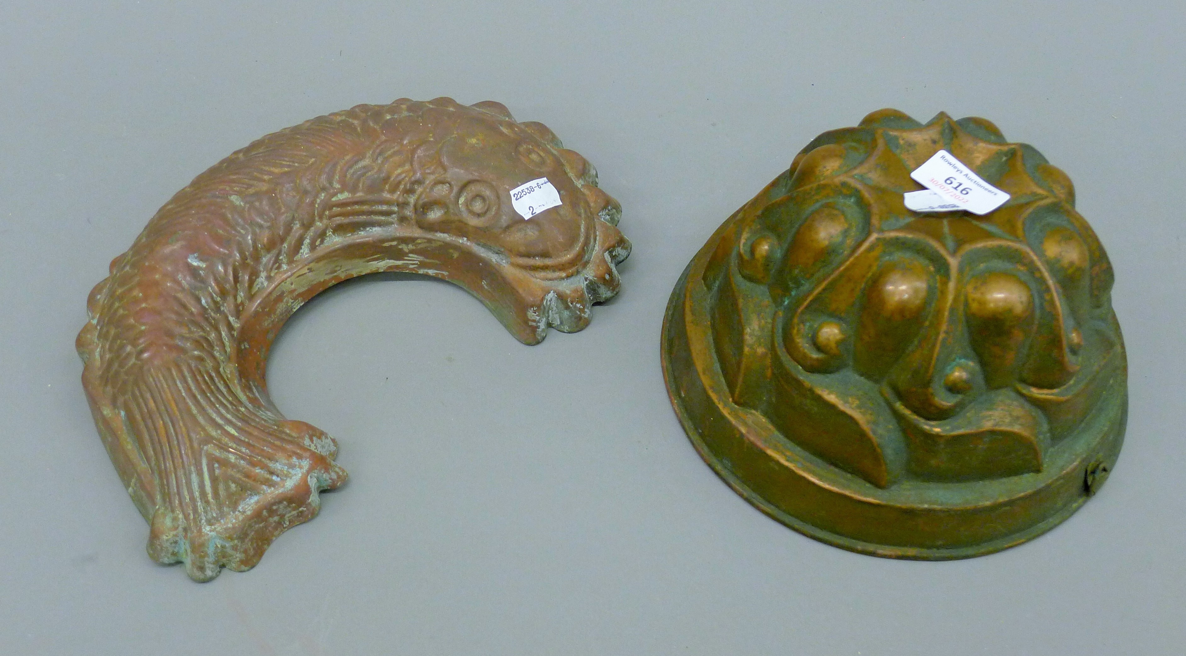 Two copper moulds. The largest 12.5 cm high.