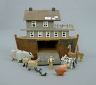 A wooden model of Noah's Ark, containing various animals and a model of Noah. 50 cm long.
