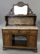 A Victorian walnut bedroom suite: comprising of a triple wardrobe, a dressing table,