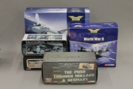 A collection of boxed Corgi military models.