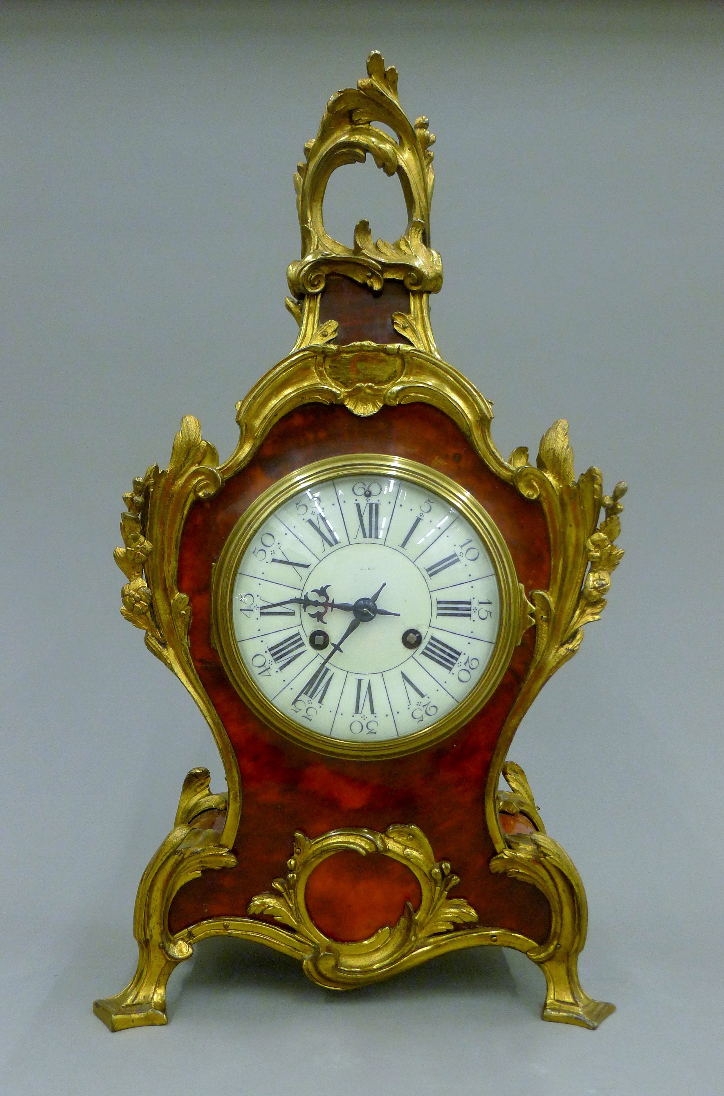 A bronze and tortoiseshell clock. 48 cm high.