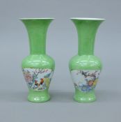 A pair of Japanese green vases with four character mark to base. 21.5 cm high.