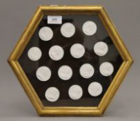 Fourteen framed Grand Tour type plaster intaglios, housed in a box frame. 29 cm wide.