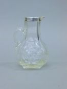 A silver rimmed and glass claret jug, hallmarked for Chester 1901 by Robert Pringle and Son.