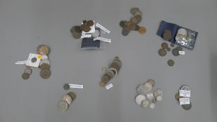 A quantity of various coins, including coins.