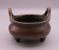 A small Chinese ring handle bronze censer. 7.5 cm wide.