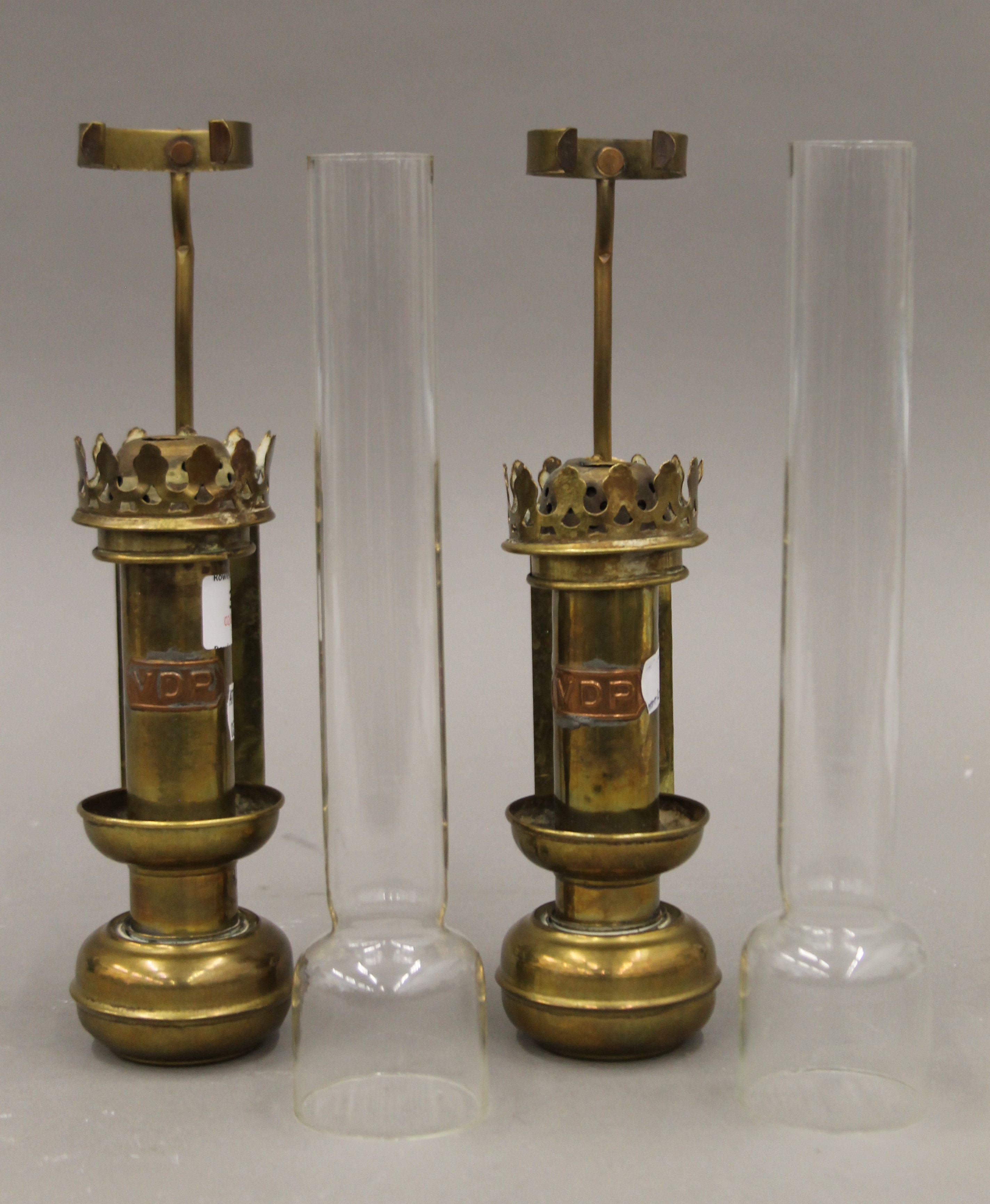 A pair of brass railway coach lamps, each with copper plaque inscribed VDP. Each 42 cm high overall.