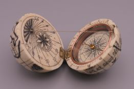 A globe form compass. 6 cm high.