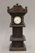 A carved miniature longcase clock. 40 cm high.