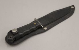 A Tramontina Brazilian fishing knife, in sheath. 24.5 cm long.