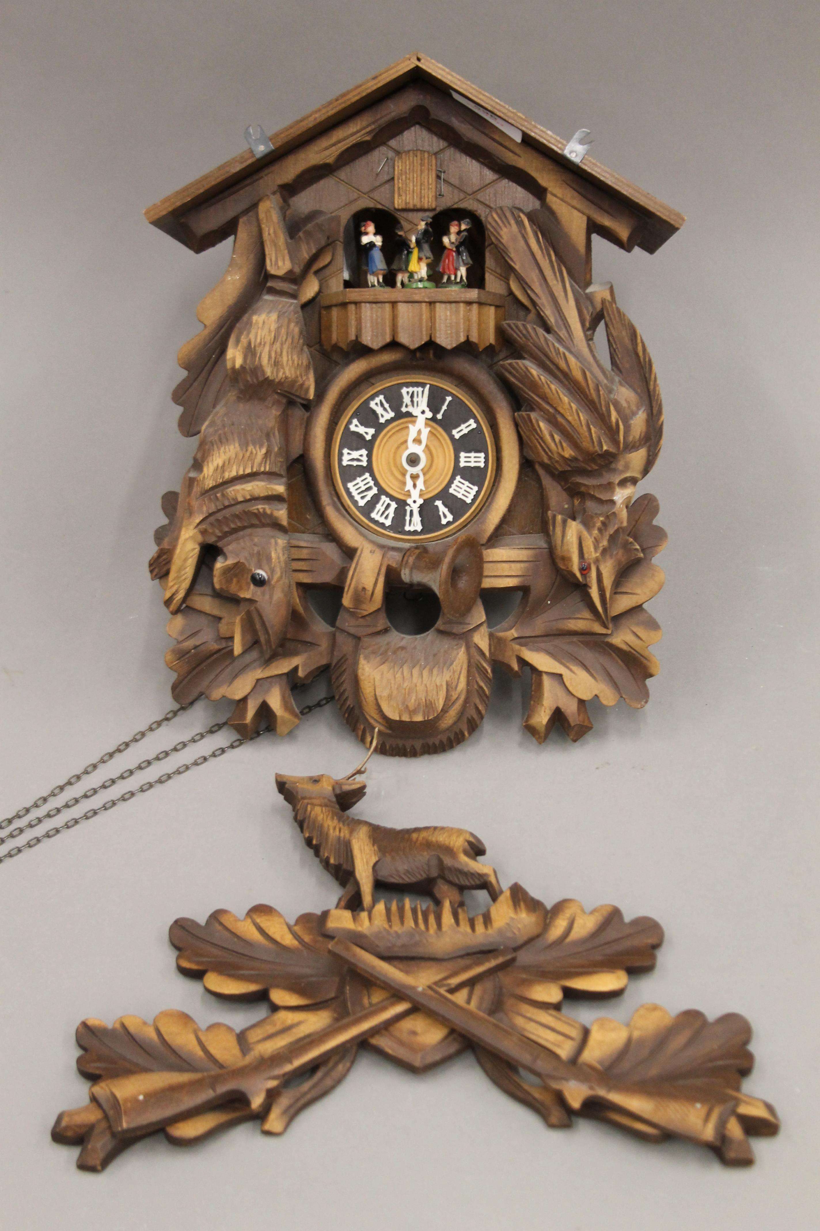 A Blackforest cuckoo clock with roundabout. Approximately 49 cm high.
