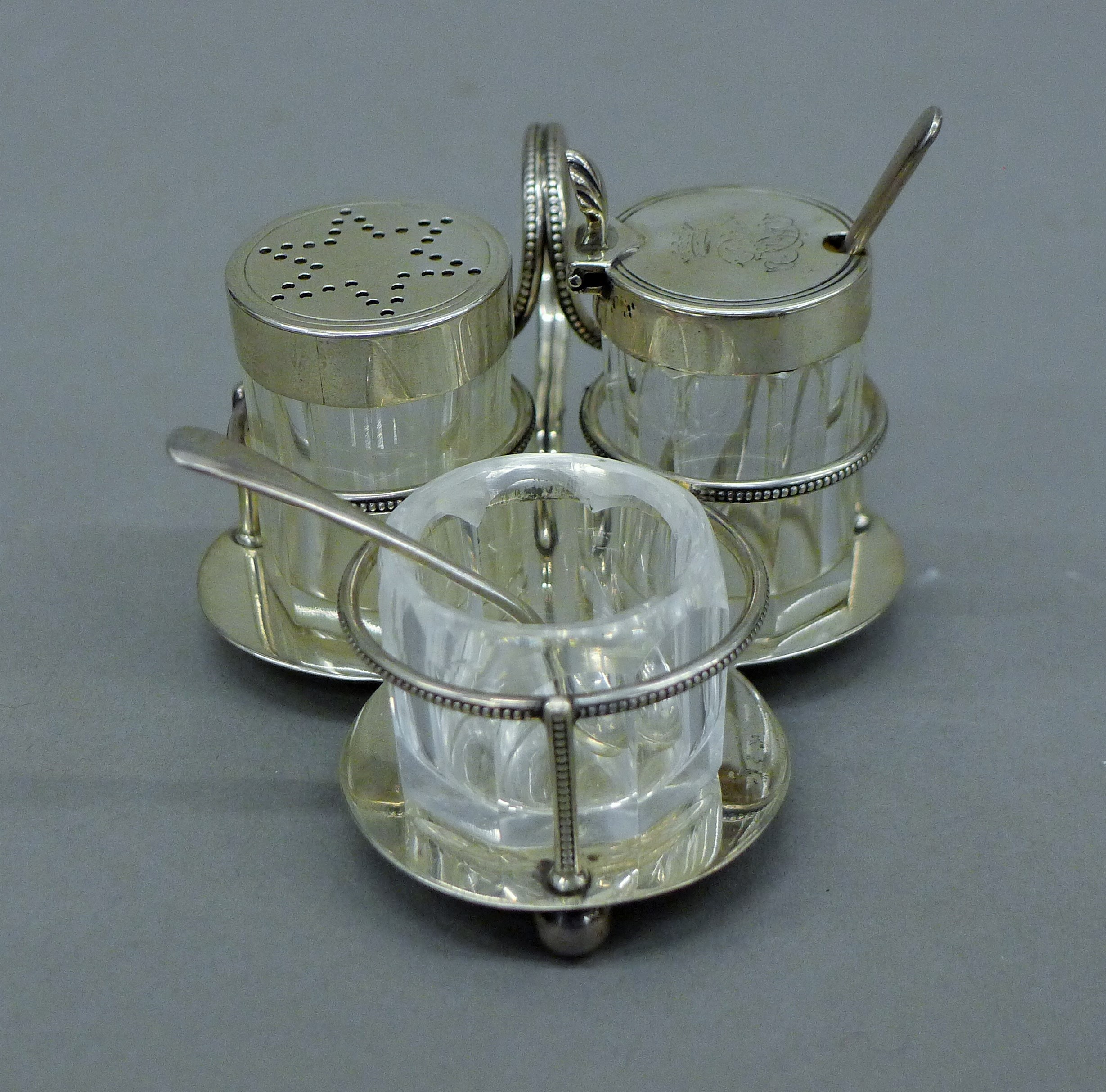 A silver condiment set, hallmarked for London 1882, makers mark Hukin & Heath. 8.5 cm long.