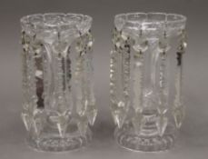 A pair of clear glass lustres. Each 23 cm high.